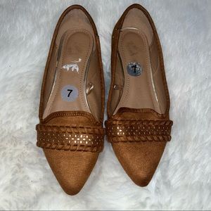 Camel colored flat shoes.